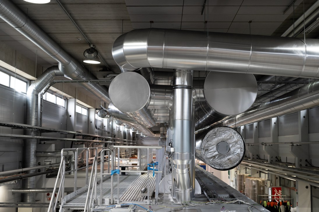 Wide view of Spinnova's industrial factory floor with large machinery and processing equipment