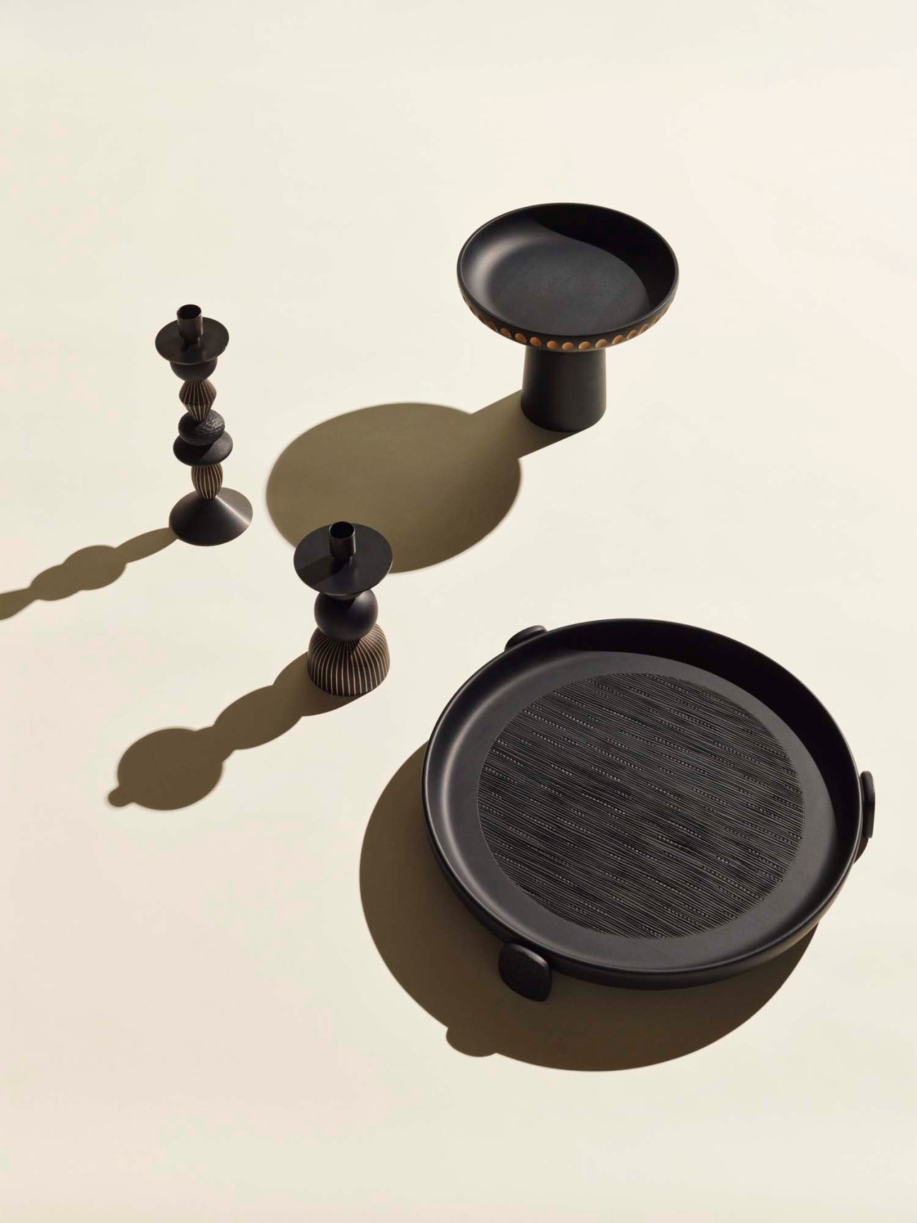 Black-stained maple bowls and tableware with hand-carved details