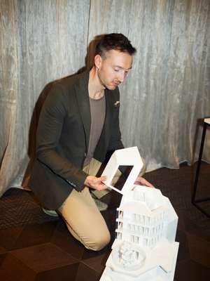 Stefan F Höglmaier, founder of Munich-based developer Euroboden, examines an architectural model of a building.