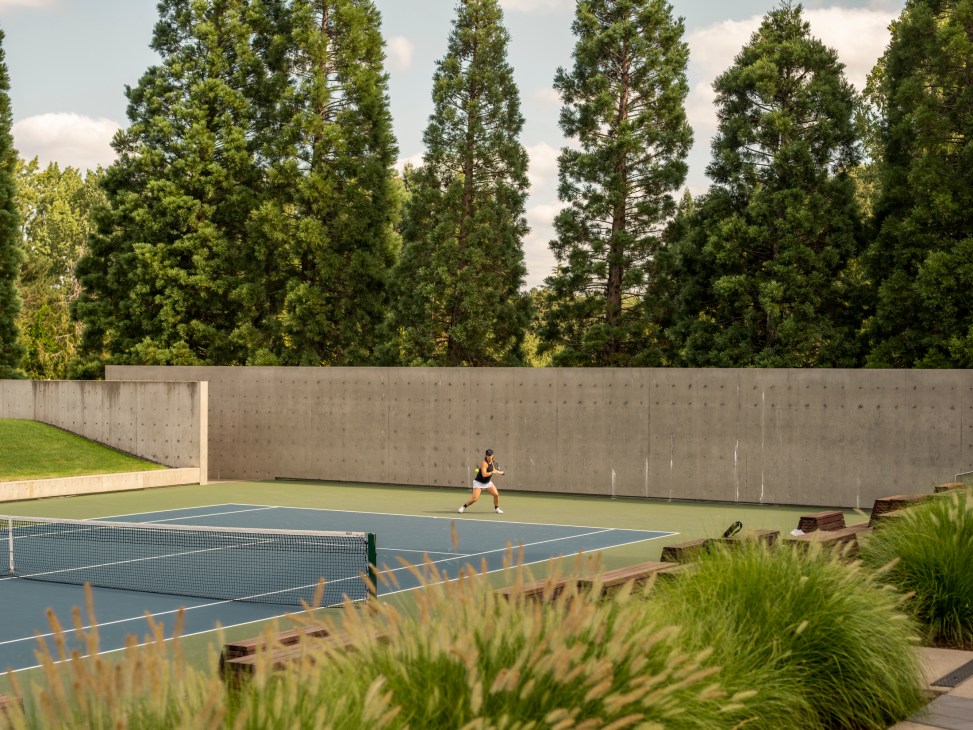 Tennis court at Nike headquarters with player practicing against concrete wall