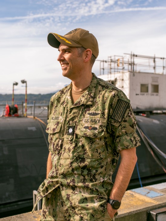 Naval repair officer working on submarine equipment