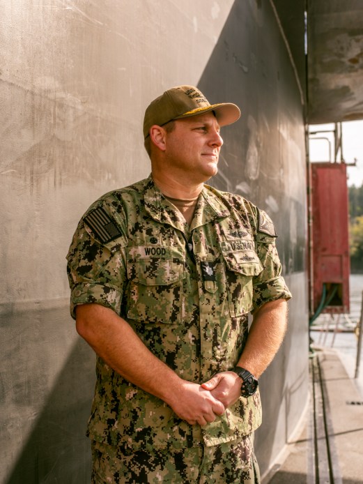 Navy commander in uniform standing in submarine control room