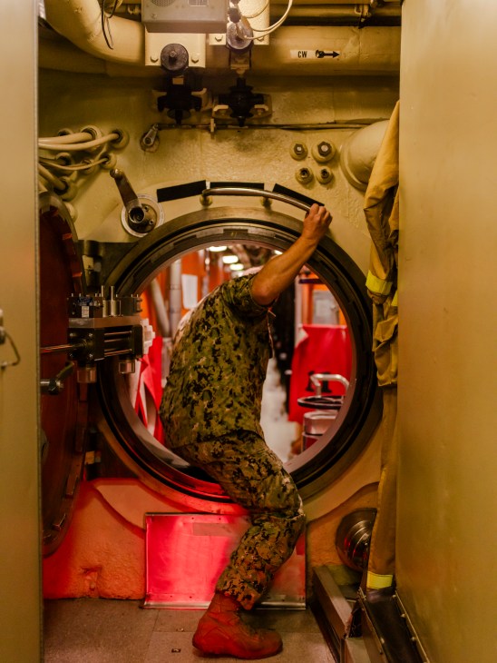 Interior view of submarine crew quarters showing cramped living conditions
