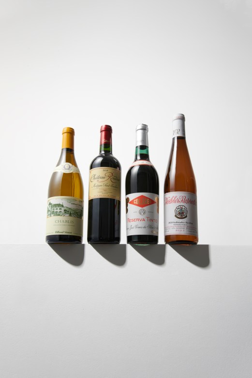 Four wine bottles arranged in a row against white background showing different label designs and bottle shapes