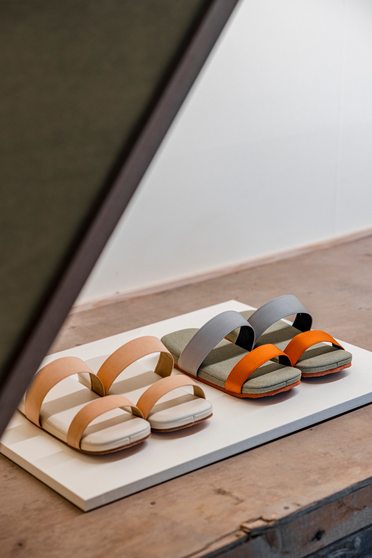 Three pairs of modern zouri sandals with colorful straps displayed on a white platform.