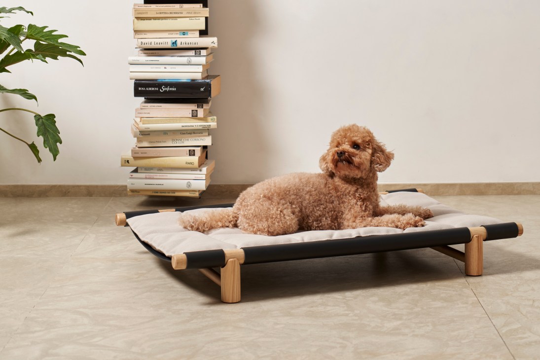 Berberé pet bed by Opinion Ciatti with wooden frame and black leather cushion on light wooden floor