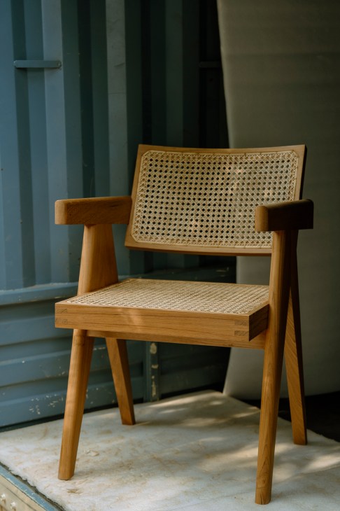 Craftsman working on wooden chair frame in Phantom Hands workshop in Bangalore