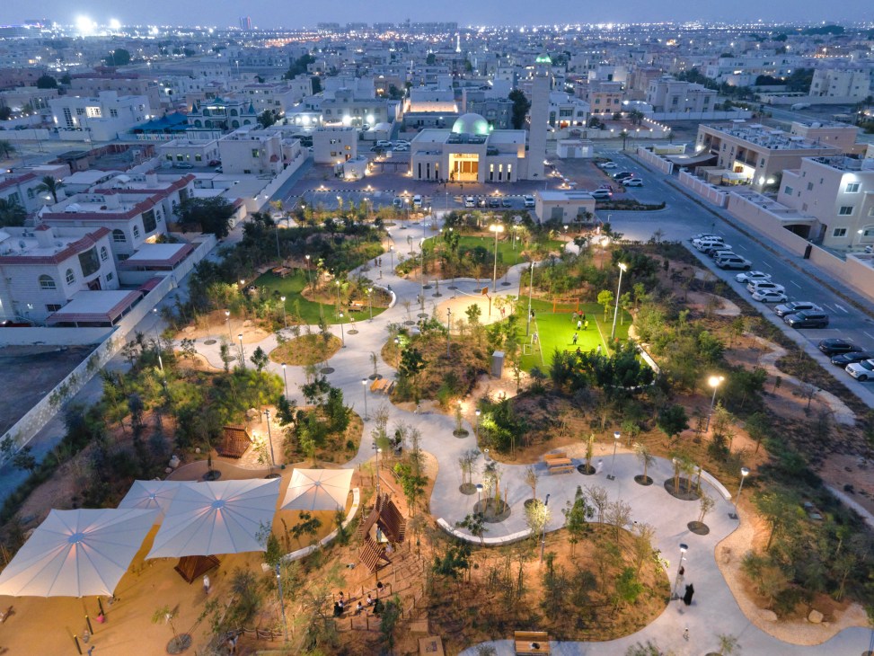 Aerial view of Khalifa Pocket Parks showing green spaces with sports courts and landscaping in desert urban setting