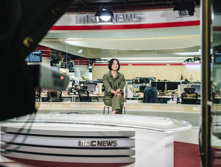 Kang Da-som, an announcer for South Korea's MBC network, recording a news item in a broadcast studio.