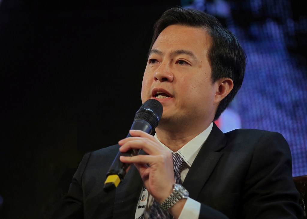 Leslie Thng, CEO of Scoot airline, speaking into a microphone while wearing a dark business suit