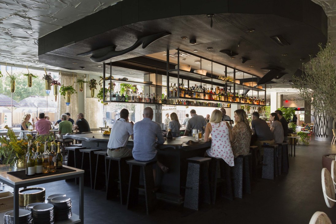 Modern bar and restaurant interior at The Line Austin hotel with mid-century design elements and contemporary furnishings