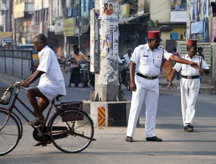 policeman directs traffic wearing a French-style uniform