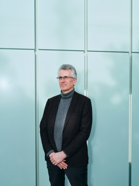 Pascal Eveillard, standing in front of glass walls