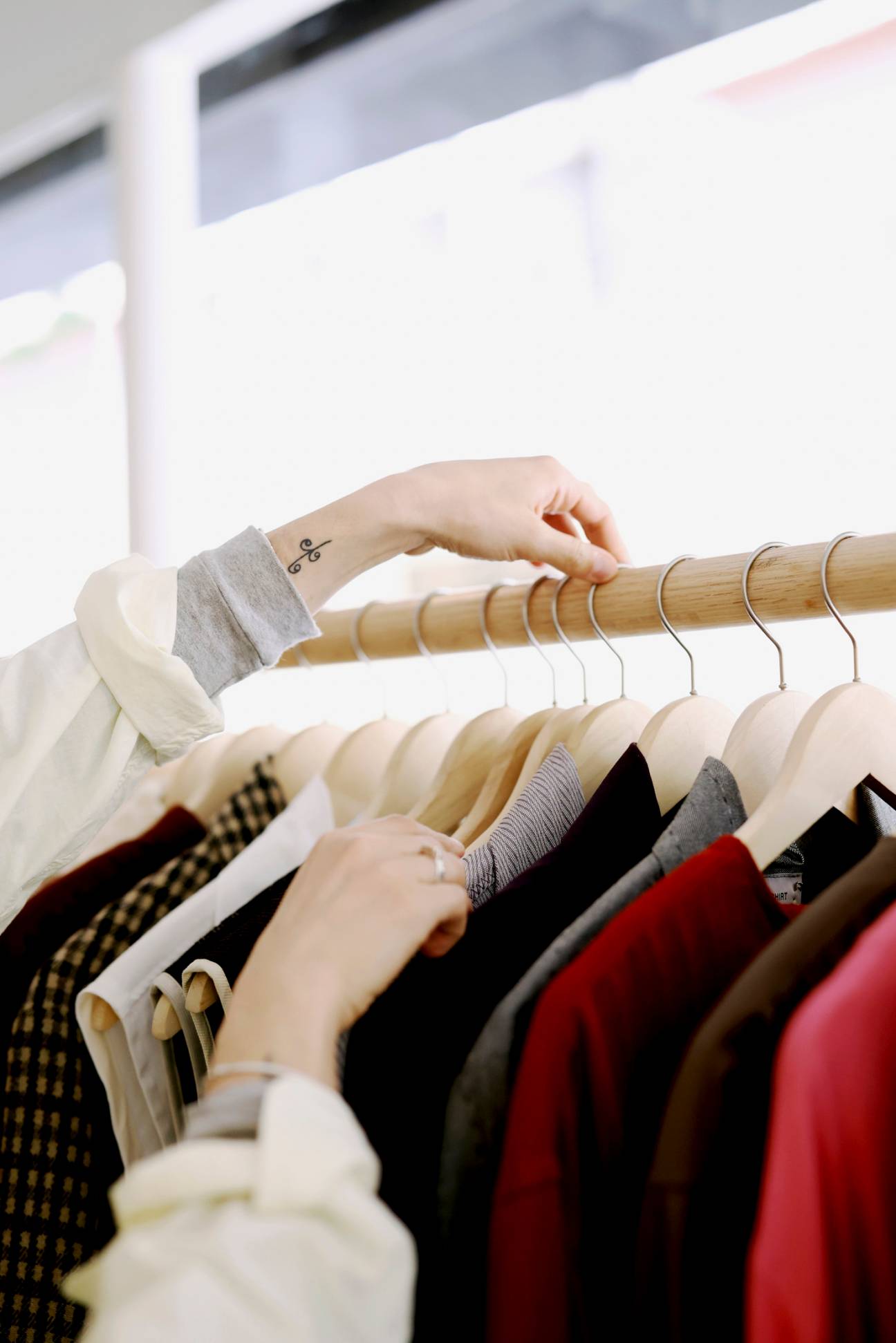 Christina Christodoulou arranging clothes on a rail.
