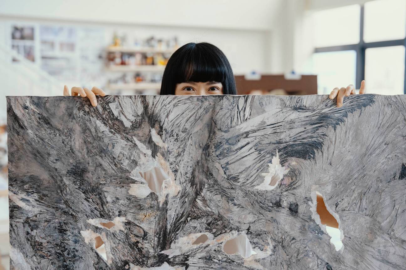 Dawn Ng with one of her paintings.