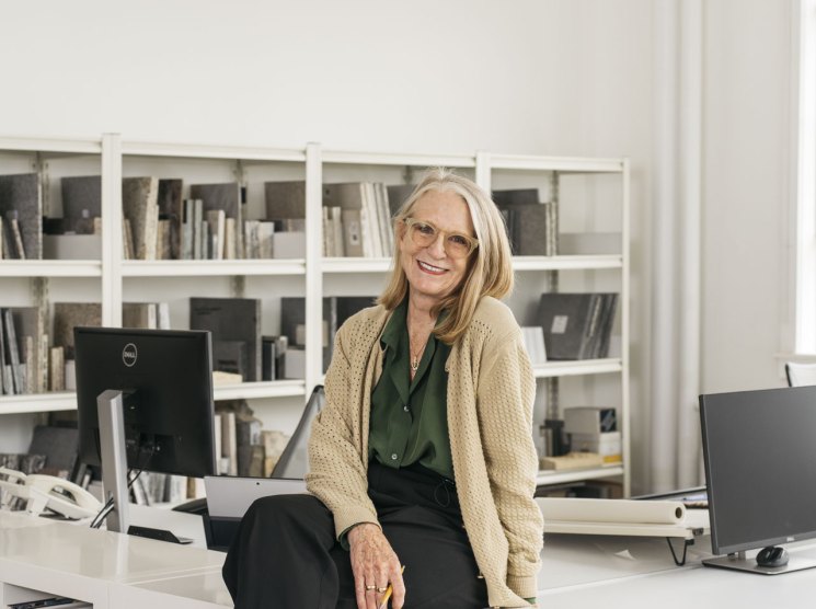 Kathryn Gustafson, landscape architect and co-founder of GGN, sits at her desk smiling at the camera.