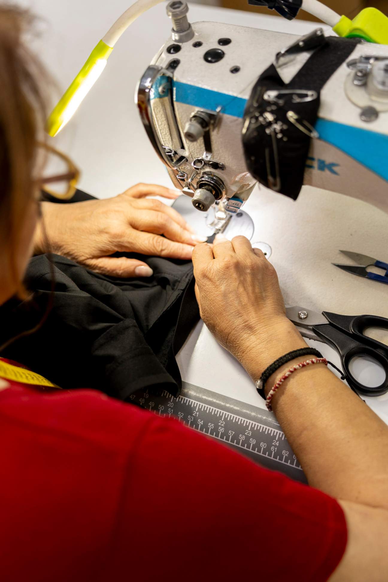 A lady at a sewing machine.
