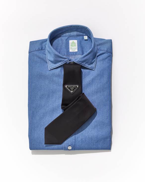 Black Prada tie with triangular logo worn with light blue dress shirt