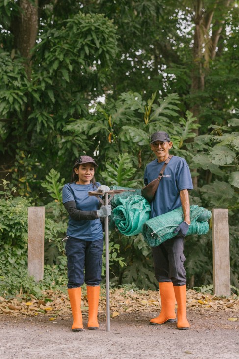 Sungai Watch volunteer wearing protective gear for river clean-up
