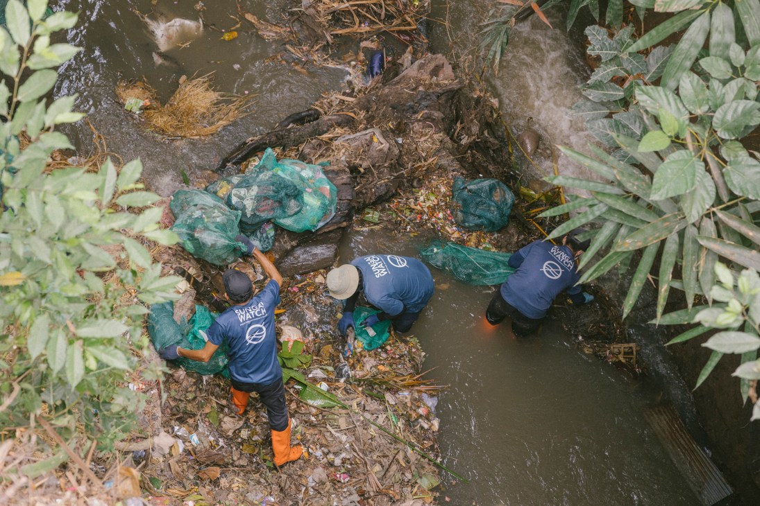 Sungai Watch team installing plastic barriers in a Bali river