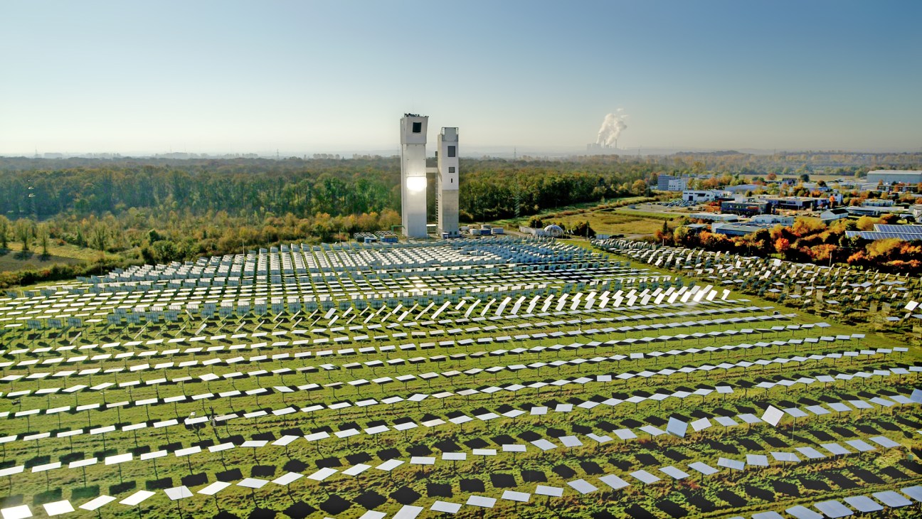 Aerial view of Synhelion's solar thermal facility with thousands of mirrors surrounding two towers in Jülich, Germany