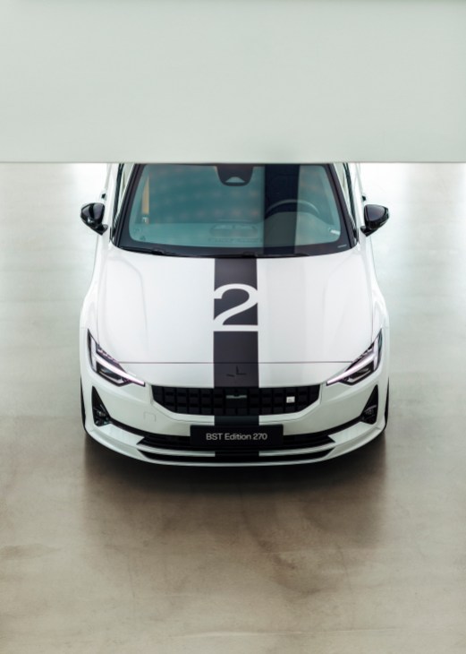 White Polestar 2 electric vehicle with black racing stripes and number 2, front view in minimal studio setting