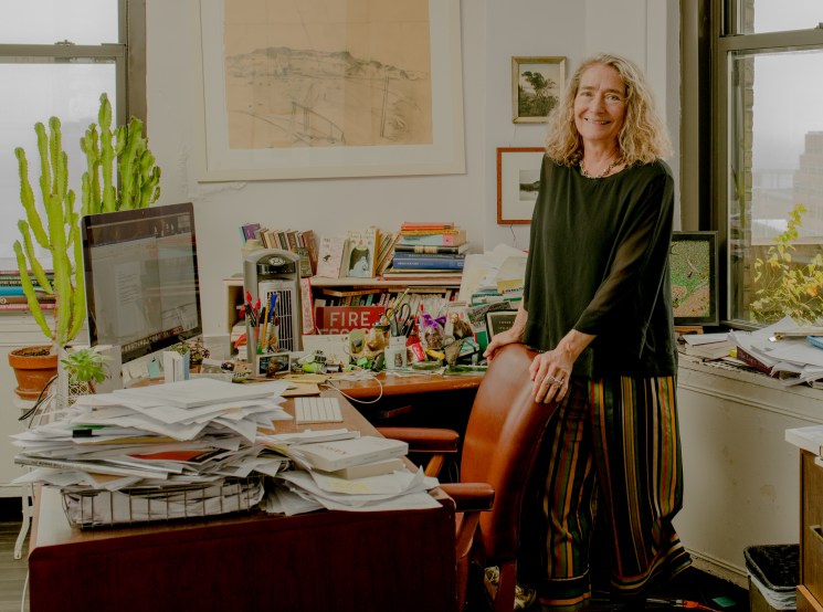 Barbara Epler, president of New Directions publishing house, poses in her downtown Manhattan office surrounded by books and papers.