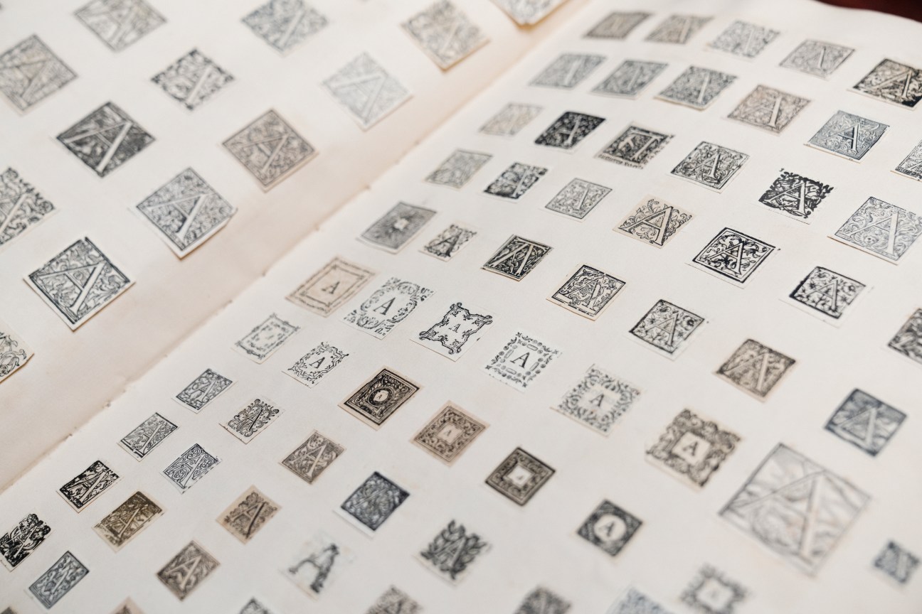 Pages from a 19th-century scrapbook showing ornate capital letters and decorative typography