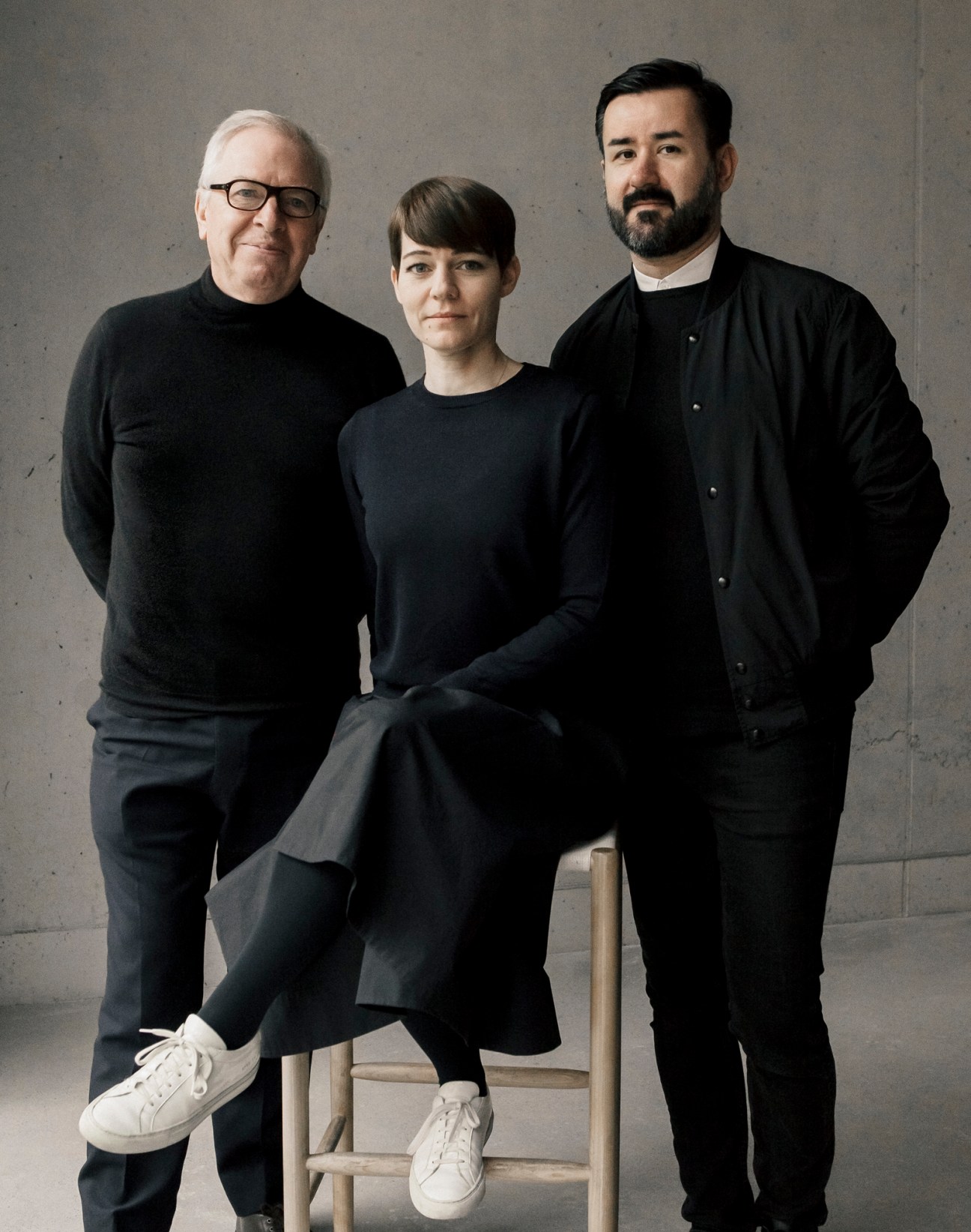 David Chipperfield with Tsatsas founders Esther and Dimitrios posing for portrait in black clothing