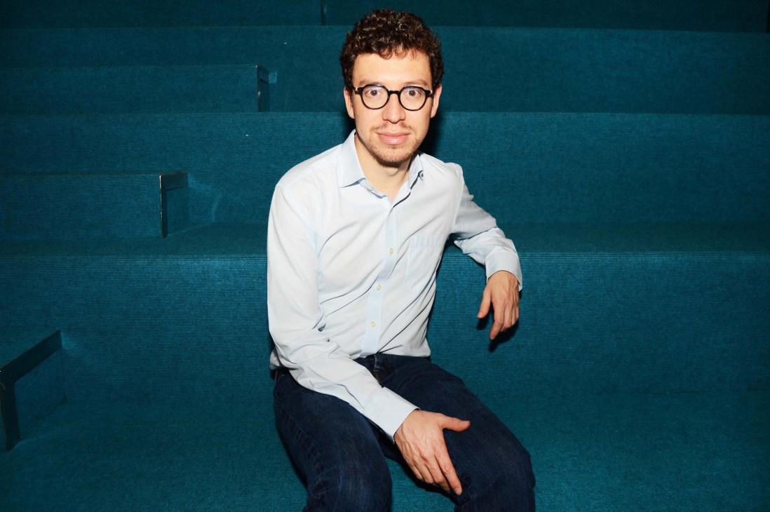 Luis von Ahn, founder of Duolingo, wearing glasses and a light blue shirt against a teal background.