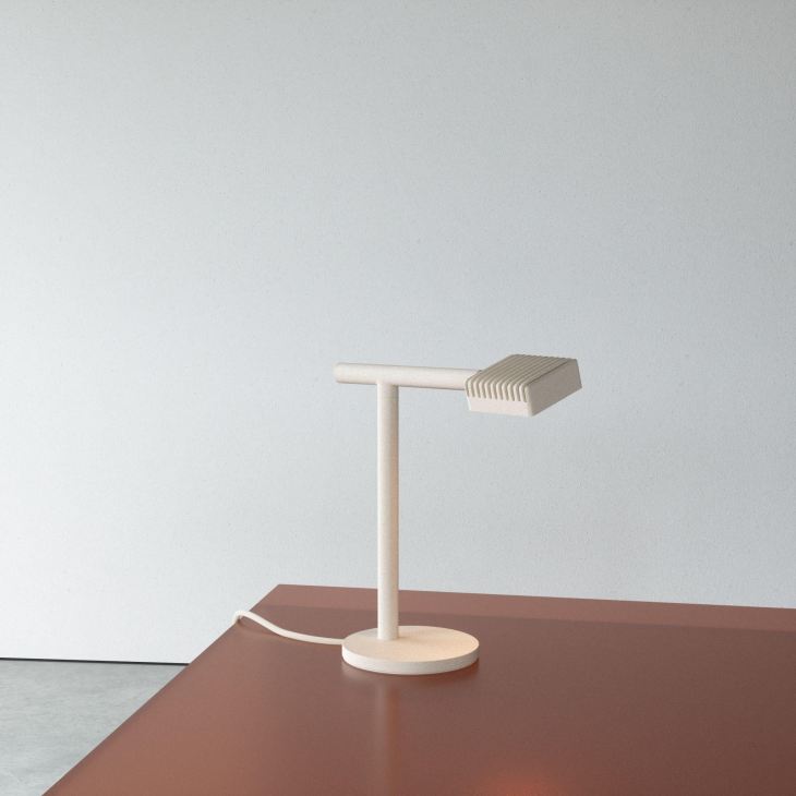 Minimalist wooden desk lamp with a ribbed rectangular shade on a terracotta surface.