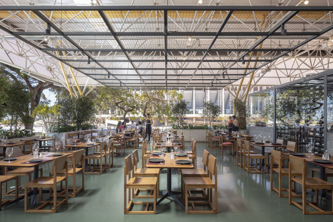 Interior view of Mané Market showing the open-air food market with breezy interiors and green spaces