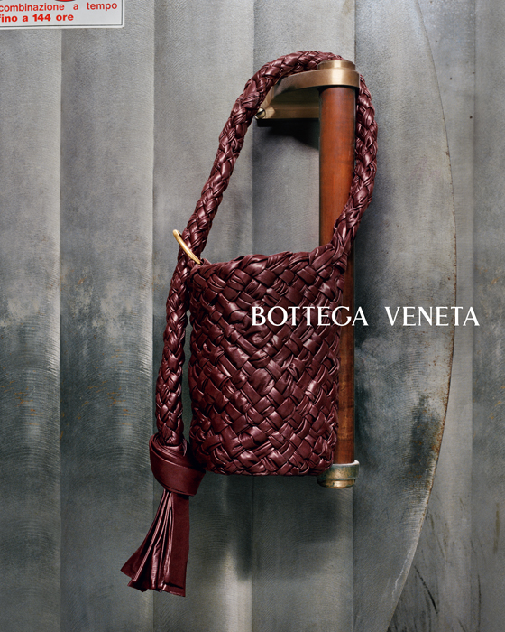 Bottega Veneta Kalimero bag in burgundy woven leather displayed against neutral background