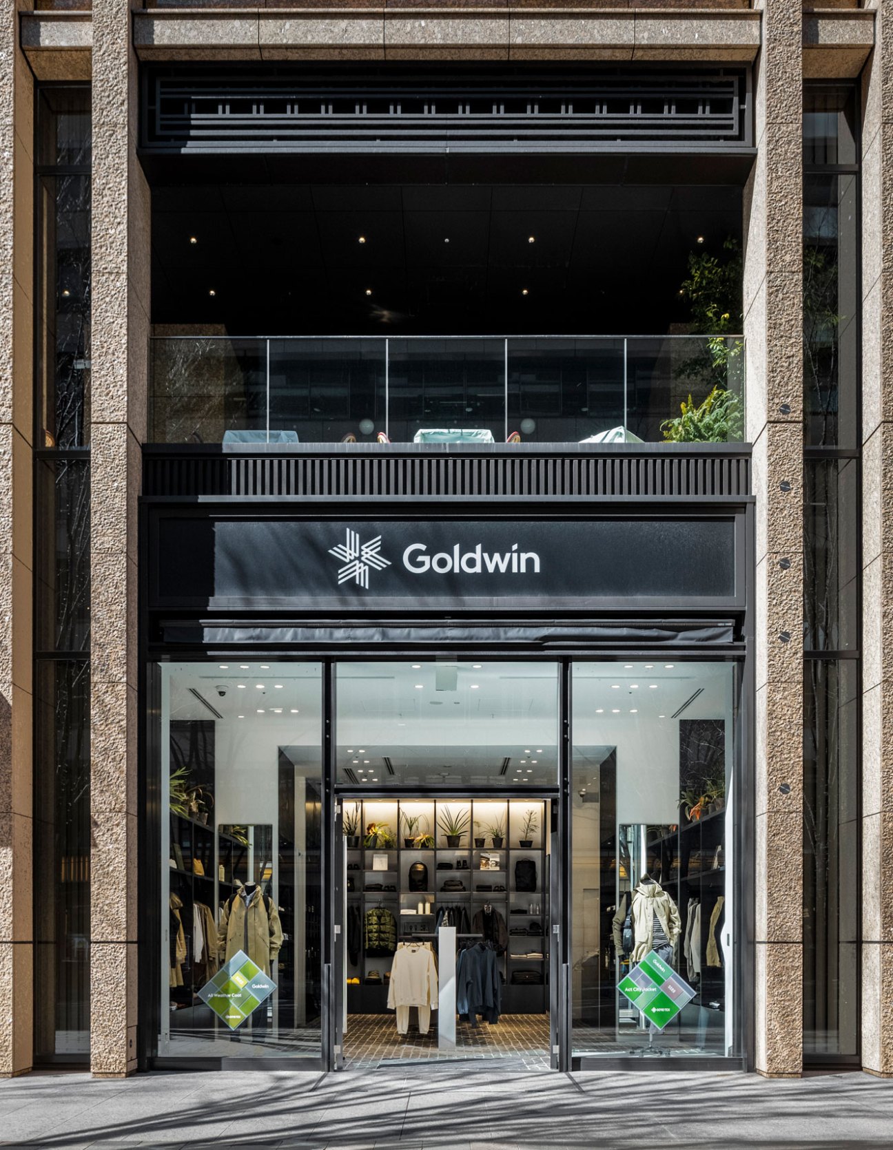 Modern Goldwin retail storefront with glass facade displaying outdoor clothing and brand signage