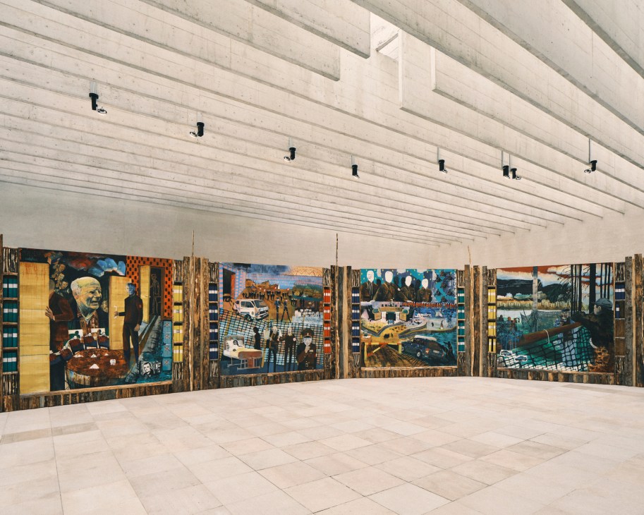 Colorful abstract paintings displayed on wooden frames in a gallery space