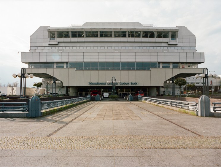 The International Congress Centre's main southern entrance, a large brutalist concrete and aluminium building with tiered levels and geometric design.