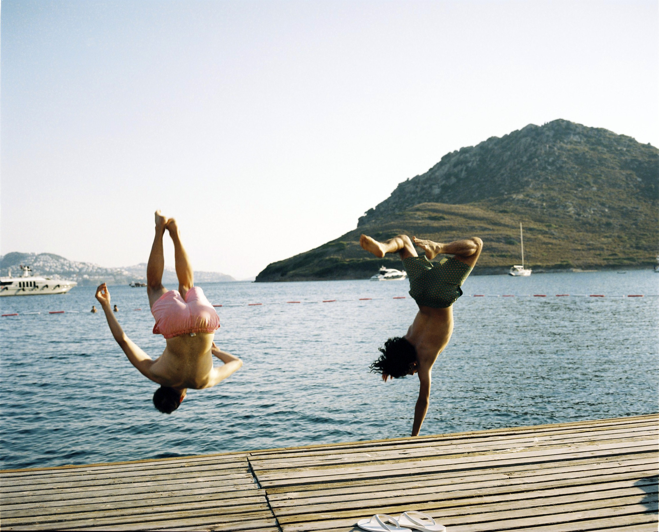 Young Turkish guys jumping in the sea