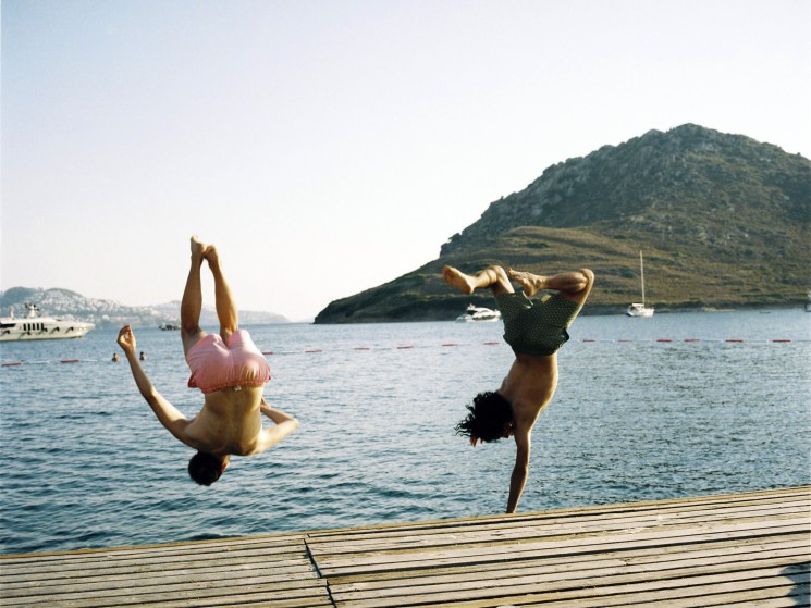 Young Turkish guys jumping in the sea