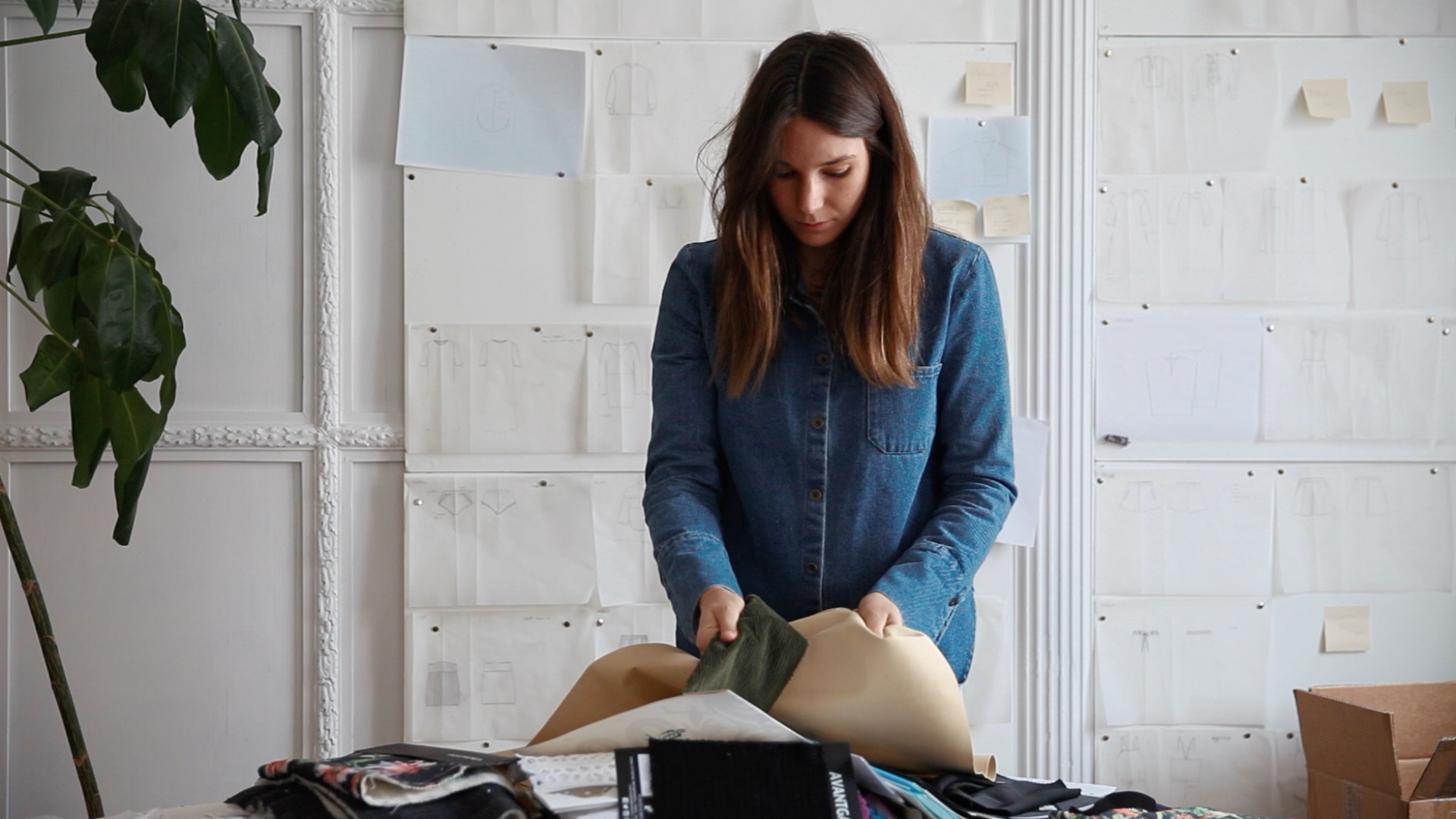 A fashion designer looking at fabrics.