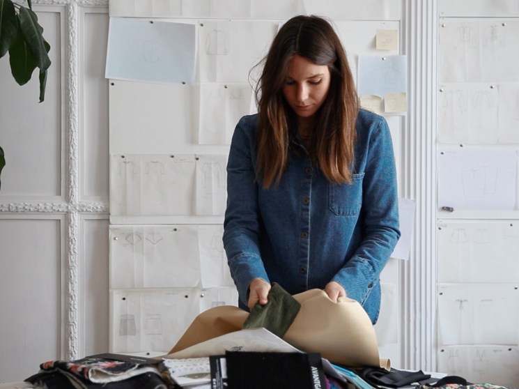 A fashion designer looking at fabrics.