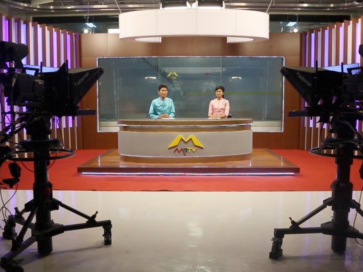 Presenters in a TV studio in Burma.