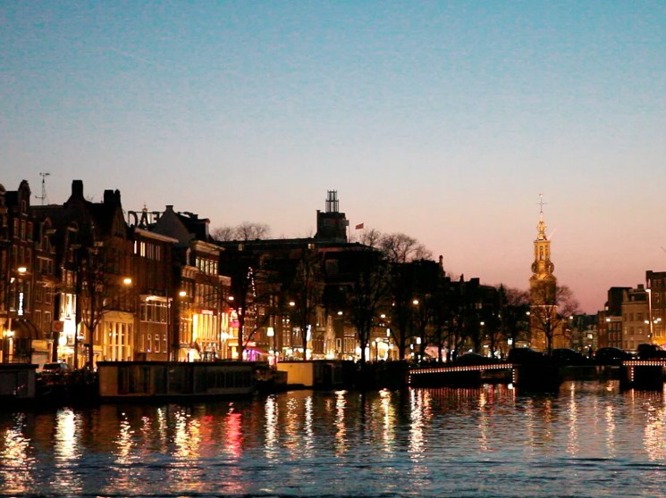 The city centre of Amsterdam at night.