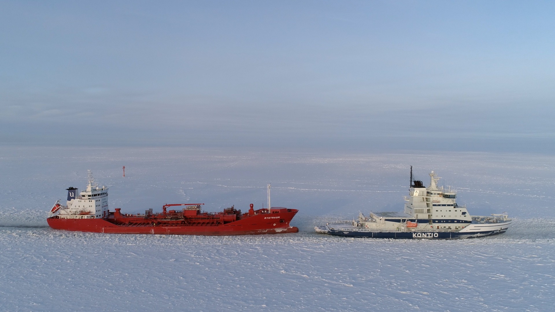 Icebreaker towing a ship