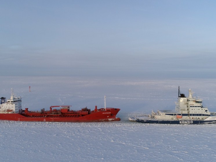 Icebreaker towing a ship
