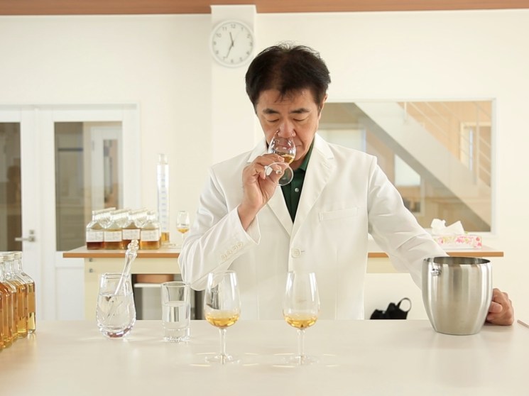 Master distiller tasting whiskey.