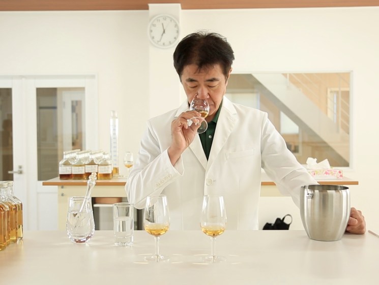 Master distiller tasting whiskey.