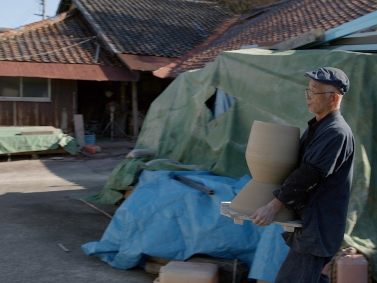 Craftsman carrying a sculpture