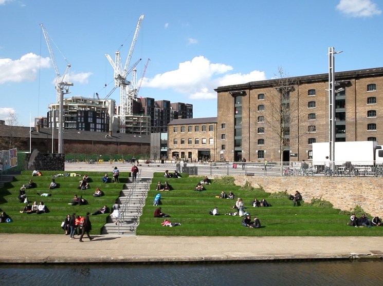 People sitting by the canal in London's Kings Cross.