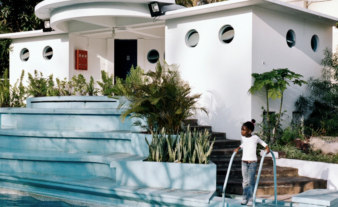 girl next to a staircase and swimming pool