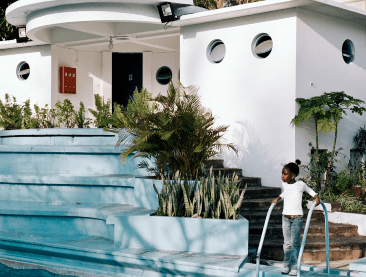 girl next to a staircase and swimming pool